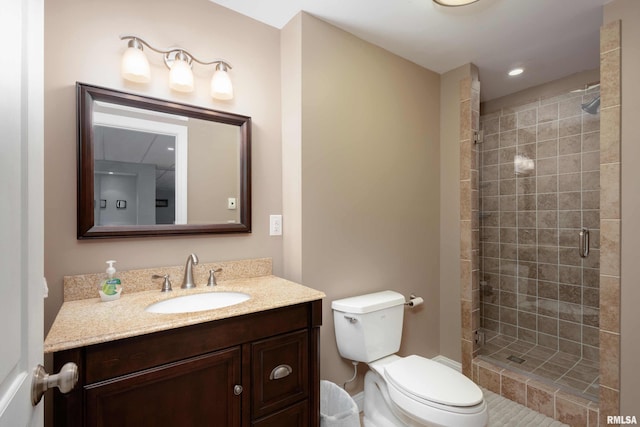 full bath featuring toilet, a stall shower, recessed lighting, and vanity