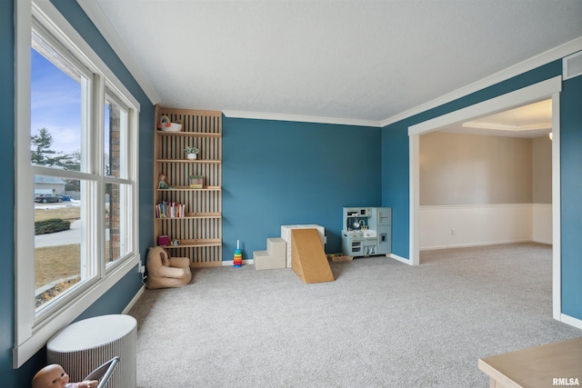 rec room with carpet flooring, crown molding, visible vents, and baseboards