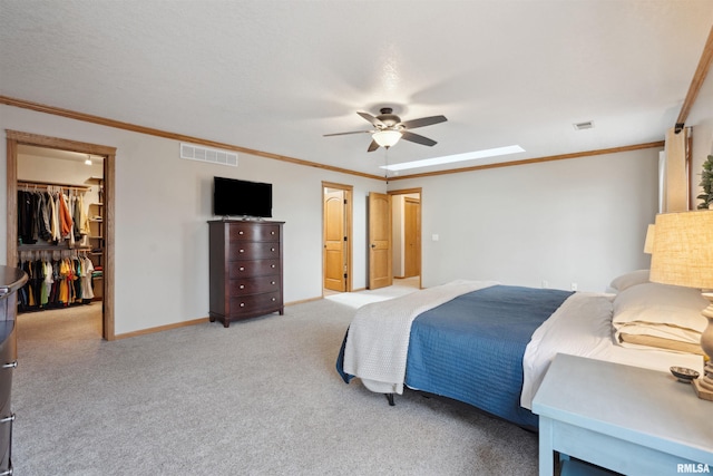 bedroom featuring ornamental molding, visible vents, a spacious closet, and baseboards