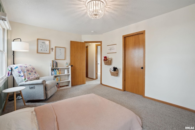 bedroom featuring baseboards, a chandelier, and light colored carpet