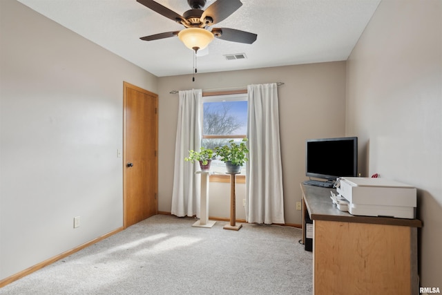 unfurnished office featuring light colored carpet, visible vents, and baseboards