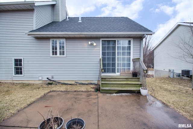 back of property featuring roof with shingles and cooling unit