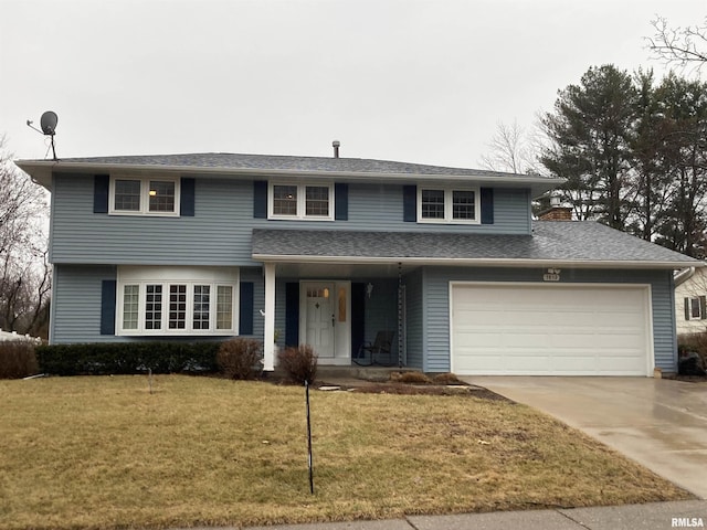 traditional home featuring driveway, an attached garage, and a front yard