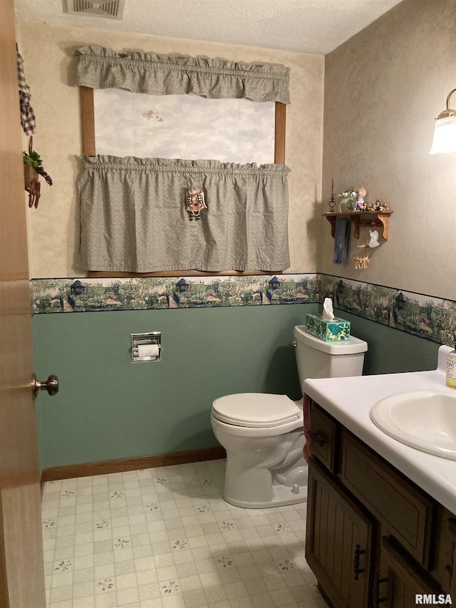 bathroom featuring tile patterned floors, visible vents, toilet, a textured ceiling, and vanity