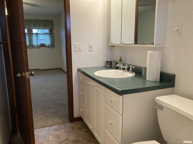 full bathroom featuring vanity, a shower stall, and toilet