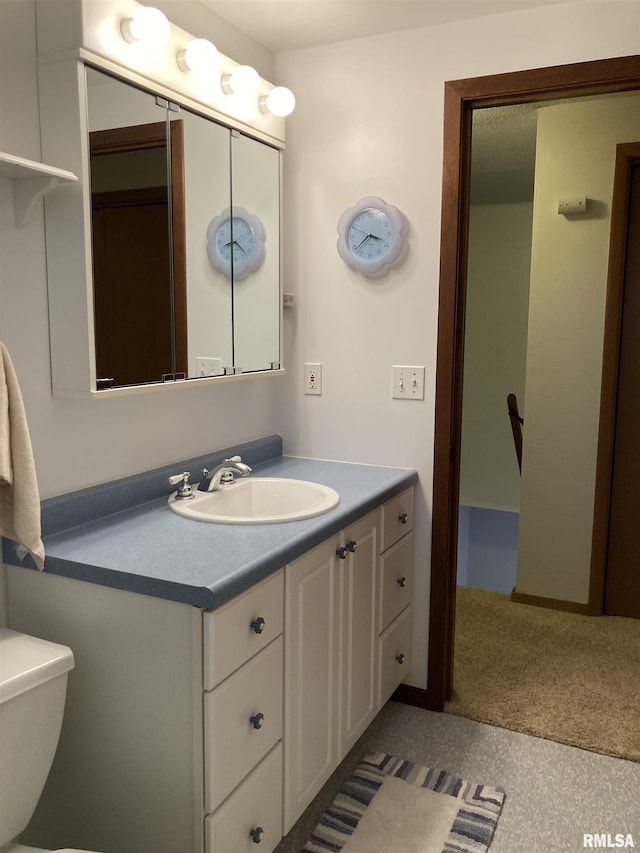 bathroom featuring vanity and toilet