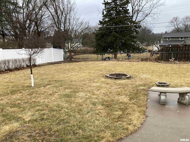 view of yard with a fire pit and a fenced backyard