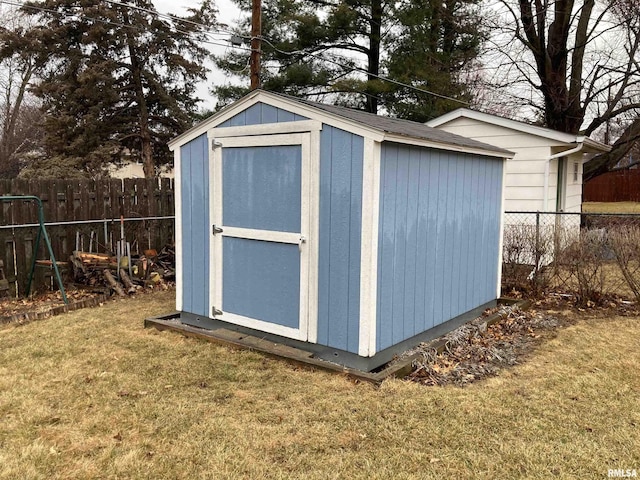 view of shed featuring fence