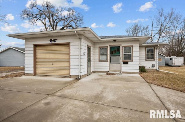 single story home featuring driveway and an attached garage