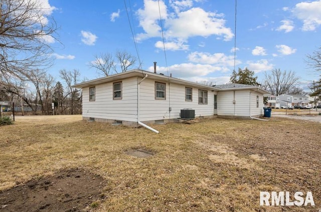 back of property with a yard and cooling unit