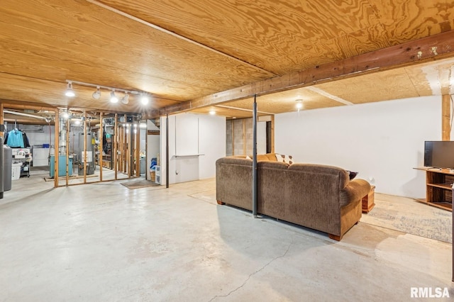 finished basement featuring washer / dryer and gas water heater