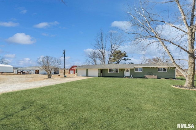 ranch-style house featuring driveway, a front lawn, and an attached garage