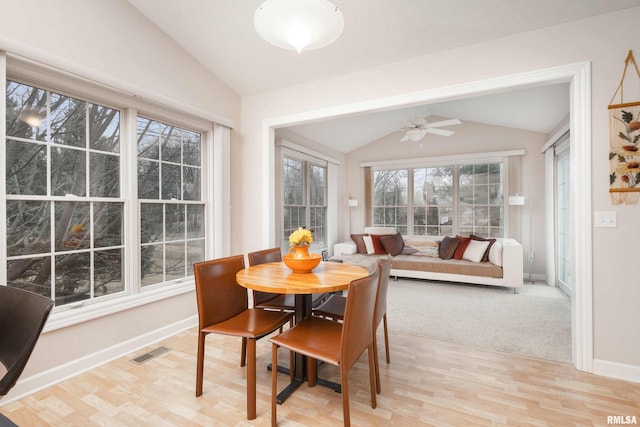 dining area featuring lofted ceiling, visible vents, light wood-style flooring, and baseboards