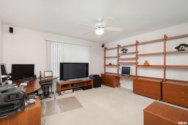 office area featuring a ceiling fan, carpet, and built in desk