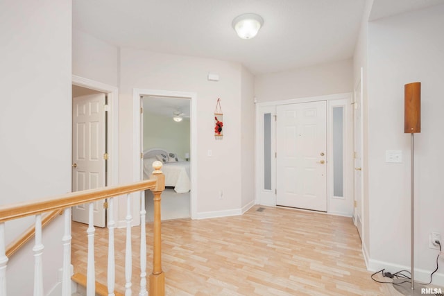 entryway featuring light wood-style flooring and baseboards