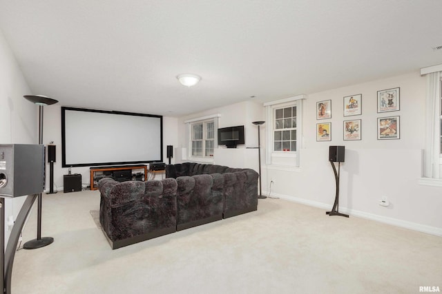 carpeted home theater room featuring baseboards