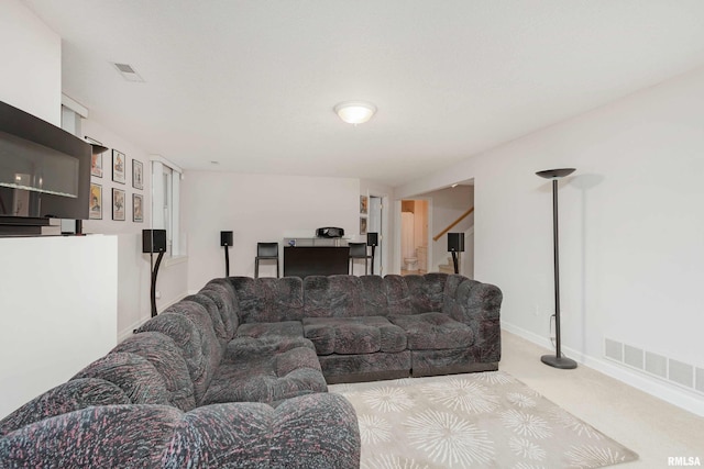 carpeted living room with visible vents and baseboards