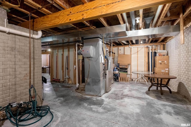 unfinished basement with heating unit and brick wall