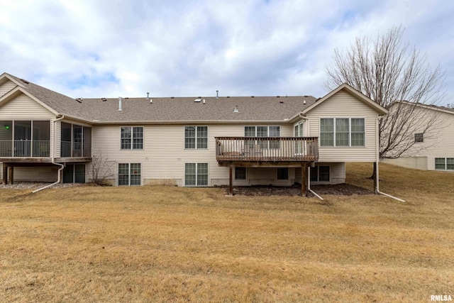 back of house featuring a deck, a yard, and roof with shingles