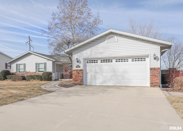 single story home with a garage, brick siding, and driveway