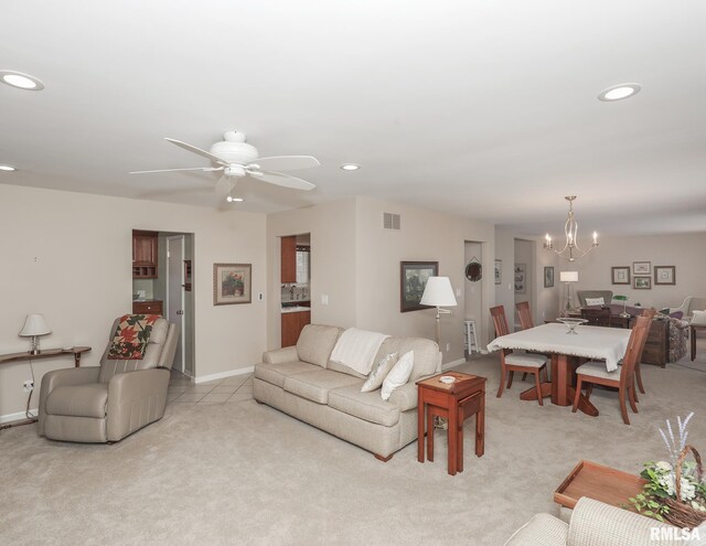 living area with baseboards, recessed lighting, visible vents, and light colored carpet