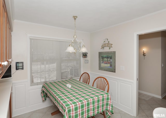 dining area featuring light tile patterned floors, ornamental molding, and wainscoting