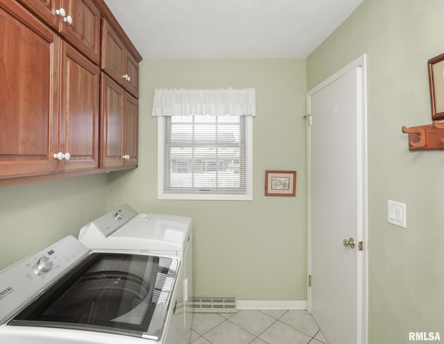 laundry area with light tile patterned floors, cabinet space, visible vents, independent washer and dryer, and baseboards