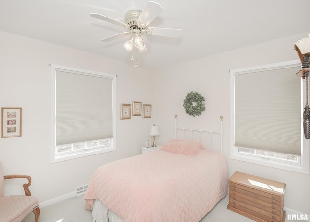 bedroom with ceiling fan, carpet floors, visible vents, and baseboards