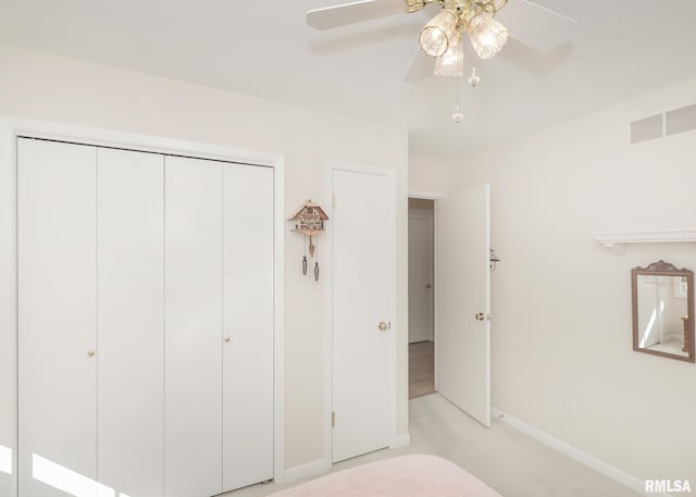 unfurnished bedroom with a closet, visible vents, ceiling fan, and baseboards