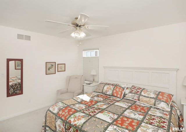 carpeted bedroom featuring ceiling fan, visible vents, and baseboards