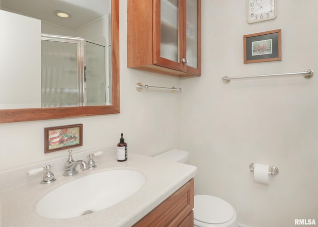 full bathroom with a shower stall, toilet, and vanity