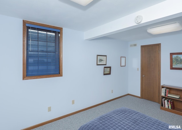 unfurnished bedroom featuring carpet, baseboards, and visible vents