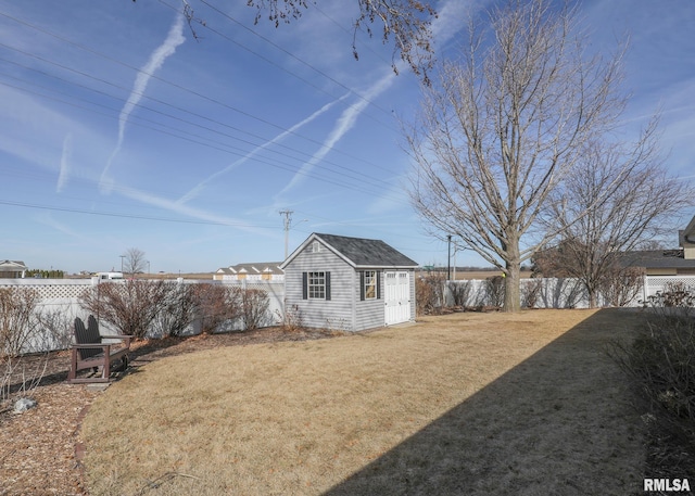 view of yard featuring an outdoor structure and a fenced backyard