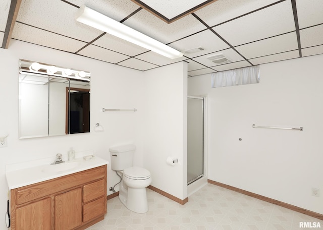 bathroom featuring a paneled ceiling, a shower stall, toilet, and vanity