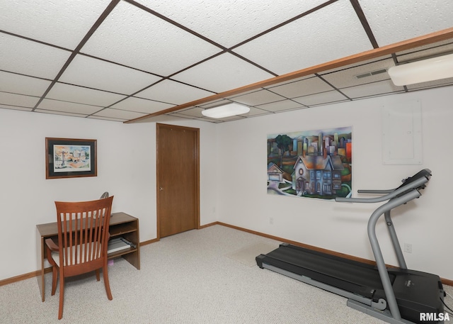 exercise room featuring light carpet, visible vents, baseboards, and a paneled ceiling