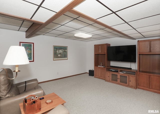 living area with light carpet, baseboards, and a paneled ceiling