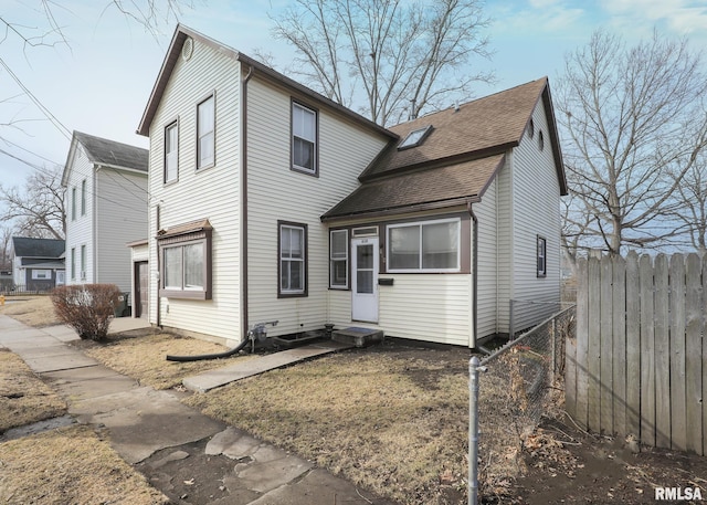 traditional home with entry steps and fence