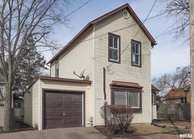 view of front of house with a garage, driveway, and fence