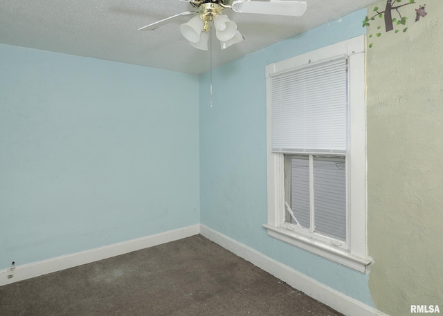 empty room with a textured ceiling, a ceiling fan, and baseboards