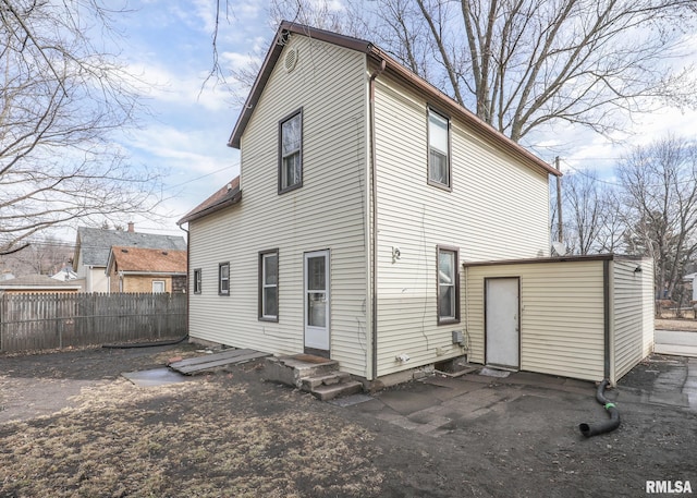 back of property featuring fence