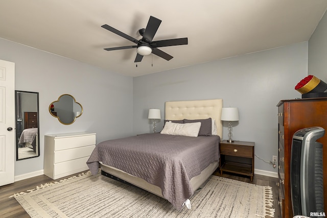 bedroom featuring ceiling fan, baseboards, and wood finished floors