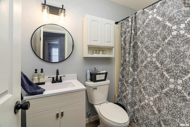 full bath featuring toilet, a shower with shower curtain, and vanity