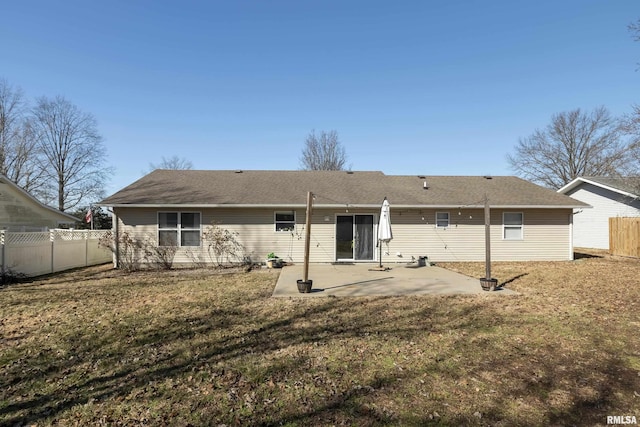 rear view of property with a yard, fence, and a patio