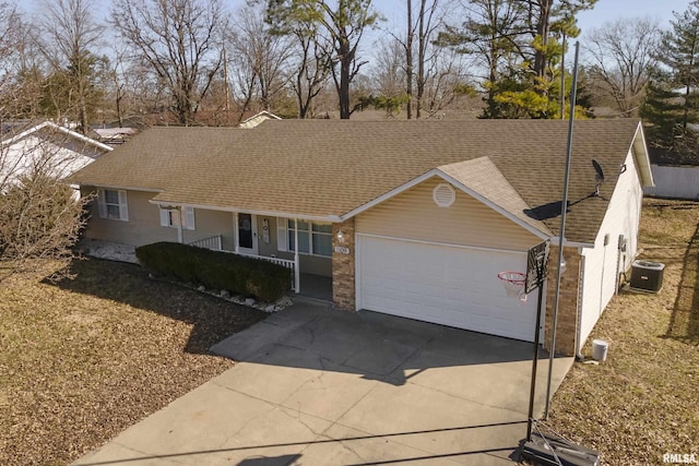 single story home with a porch, a shingled roof, concrete driveway, an attached garage, and cooling unit