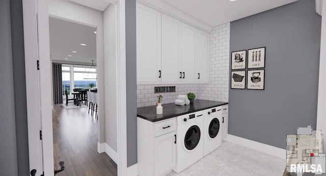 laundry room with independent washer and dryer and baseboards