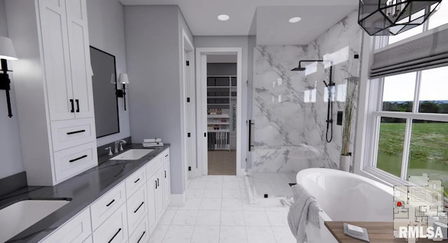 bathroom with double vanity, a marble finish shower, a freestanding tub, a sink, and recessed lighting