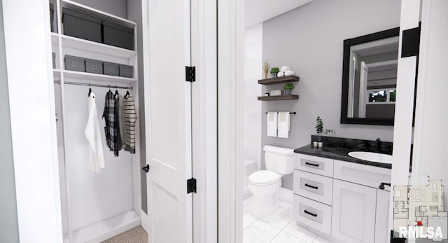 bathroom featuring marble finish floor, vanity, and toilet