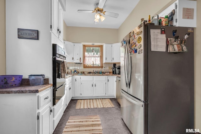 kitchen featuring white cabinets, ceiling fan, appliances with stainless steel finishes, backsplash, and a warming drawer