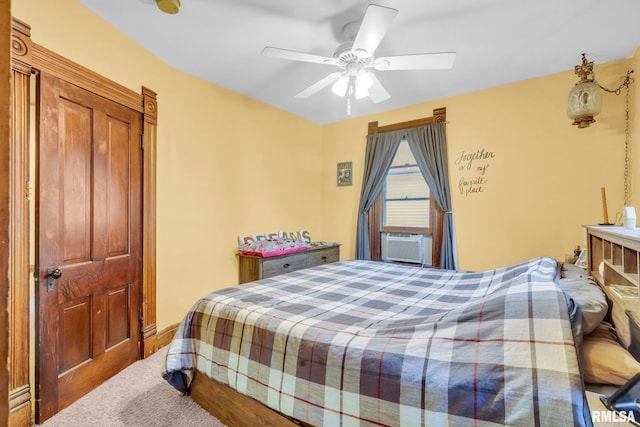 bedroom featuring carpet, cooling unit, and a ceiling fan