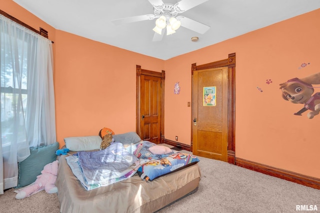 carpeted bedroom featuring ceiling fan and baseboards